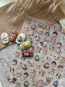 Macro view of 3D embossed dog nail stickers with Shiba Inu and poodle designs
