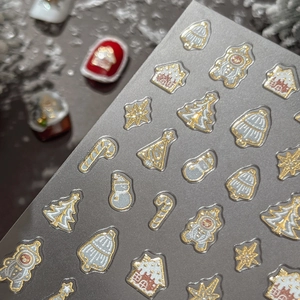 3D embossed Christmas nail art stickers with gold foil trees, gingerbread and snow houses