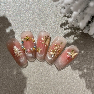 Christmas press-on nails with red gradient glitter and 3D metallic snowflake charms