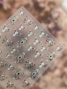 Macro view of baroque nail stickers with silver patterns and micro pearl decorations