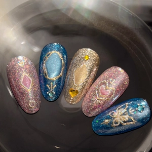 Handmade pink and blue glitter press-on nails with luxury gold 3D frames and heart gems