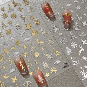 3D Christmas nail stickers with gold and silver snowflakes and elk on festive red nails