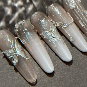 Silver gradient cat-eye almond press-on nails with 3D butterfly and chain charms