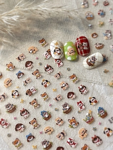 Close-up of cute cartoon cat nail art stickers with pearl accents on linen background