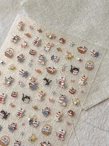 Detailed view of 3D cat embroidery patches with fine stitching on linen background
