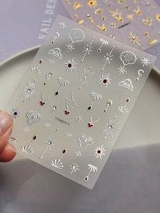 Close-up of 5D embossed nail stickers with silver stars and red bohemian patterns