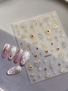 Detail of YT6803Me S nail stickers with gold sun and moon patterns on purple cat-eye nails