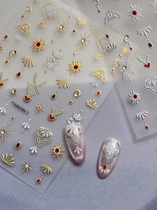 Macro detail of Bohemian nail stickers with gold sun, moon, and astrology patterns