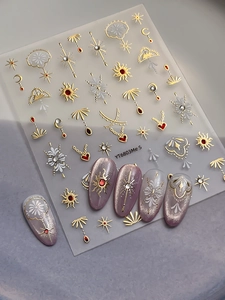 Detail of 5D Bohemian nail stickers with gold sun and moon patterns and red rhinestones