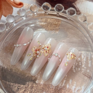 Luxury pearl nail art stickers with gold floral design and white pink gradient finish