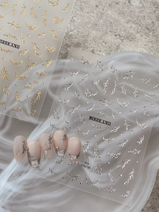Detail of metallic gold and silver leaf nail art stickers with Woodland branding