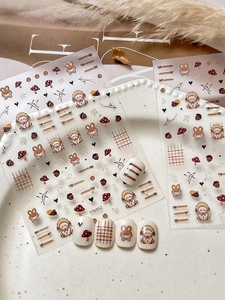 Cute bunny nail art stickers featuring coffee-colored rabbits and bows on nail tips
