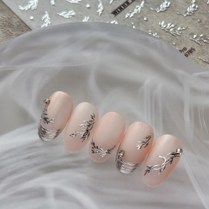 Elegant press-on nails with 3D silver leaf patterns and rhinestones on soft pink base