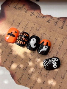 Detail of Halloween nail stickers featuring embossed ghost, spider web and bat designs