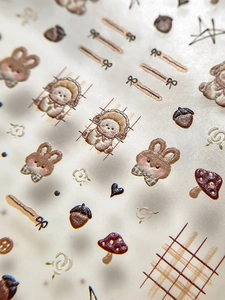 Macro detail of retro hand-drawn rabbit and bear nail art stickers with 3D embossed texture