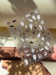 Detail view of 3D embossed Halloween nail stickers with ghosts, bats and rhinestones