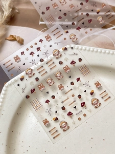 Detail of cartoon rabbit nail stickers with mushroom and forest theme in autumn colors