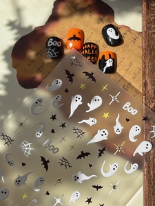 Detailed view of Halloween nail stickers with ghosts, bats and spider webs on vintage paper