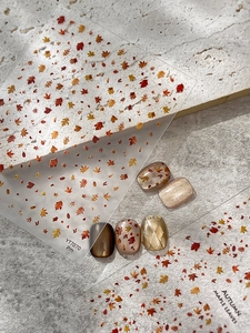 Detailed autumn maple leaf nail stickers on cat eye effect manicure on textured stone