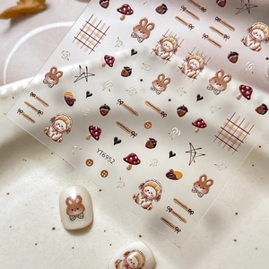 Cute brown rabbit and mushroom autumn theme nail art stickers on a textured plate