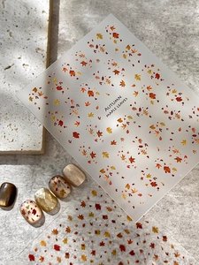 Detailed autumn maple leaf nail stickers showing various leaf patterns on manicured nails