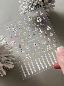 Close-up of 5D embossed Christmas nail stickers featuring silver snowflakes and trees