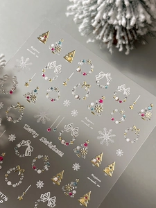 Detail view of 3D Christmas nail stickers with gold trees and pearl wreaths