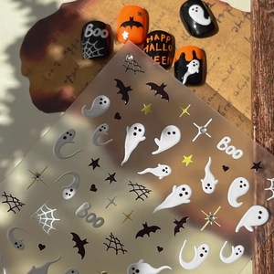 Halloween nail art set with ghost, bat, and spider web decals plus five finished press-on nails