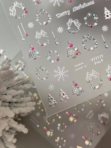 Detailed 5D embossed Christmas nail decals with silver snowflakes and tree patterns