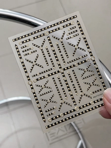 Detail view of gold chain nail stickers with geometric metallic design and circular rings