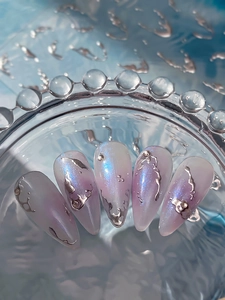 Macro detail of press-on nails with silver liquid metal relief and aurora glitter finish