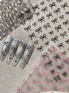 Detail of 3D embossed bow nail stickers with pearls and rhinestones on silver base