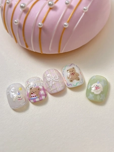 Macro shot of 3D embossed nail art featuring cute resin bears and sweet pink plaid patterns