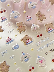 Macro detail of 3D embossed cartoon bear nail stickers with glossy resin texture