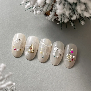 Elegant pearl white Christmas press-on nails with 3D gold trees and snowflake patterns