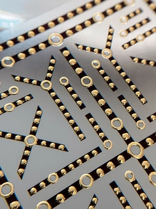 Macro shot of gold foil chain nail art stickers with glossy geometric ring and dot patterns