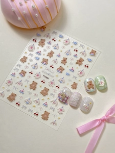 Detailed macro view of 3D embossed nail art stickers with cute bears and bunny patterns