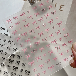 3D embossed bow nail art stickers with crystals in pink and black on a clear sheet