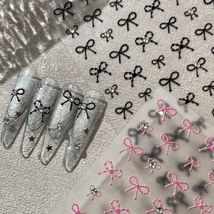 3D embossed bow nail art stickers with pearls and rhinestones in black and pink colors