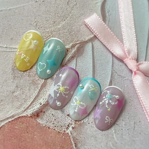 Macaron pastel nail art stickers with 3D pearls and star patterns on pink background