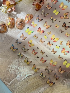Detail view of 3D embossed butterfly nail stickers with holographic laser finish