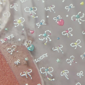 Star and bow nail stickers with pearl textures and LOVE LUCKY letters in macaron colors