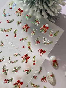 Detail of Christmas nail stickers with 3D silver laser bow and holly leaf patterns