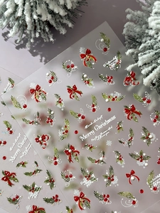 Close-up of 5D embossed Christmas nail stickers featuring bows, berries and snowflakes