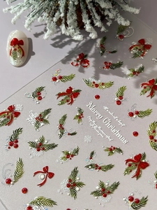 Detail of 5D embossed Christmas nail stickers with red bows and holly berry motifs