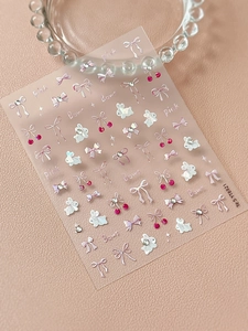 Detailed view of pink bow and bunny nail art stickers with glitter and pearl textures