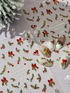 Detail of Christmas nail art stickers with red bows, green leaves and snowflake designs