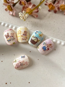 Close-up of 3D embossed rabbit nail art stickers with sweet floral and checkered patterns