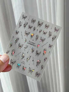Detailed macro view of YT7032 laser butterfly nail art stickers with iridescent effects