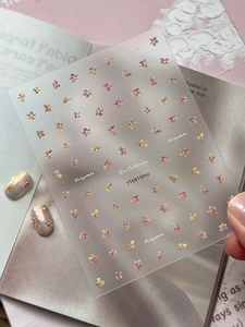 Close-up of YT6815Pro floral nail stickers with gold accents and pink flower designs